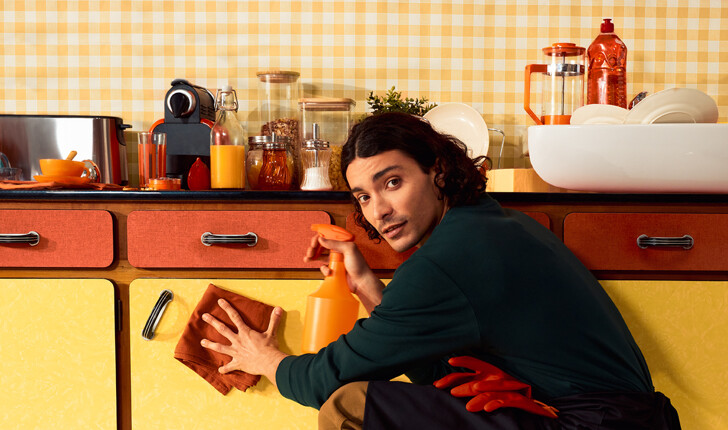 professional cleaner cleaning the kitchen with an orange cloth