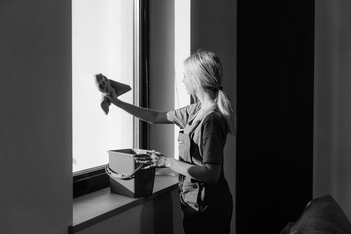 Professional cleaner cleaning the windows 