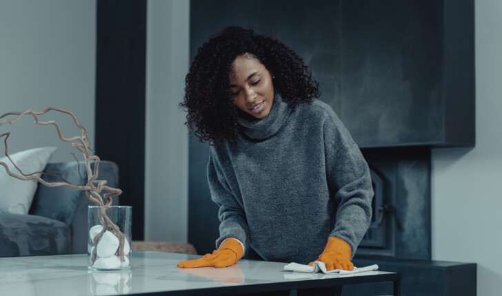 Professional cleaning lady cleaning the pantry kitchen with orange gloves