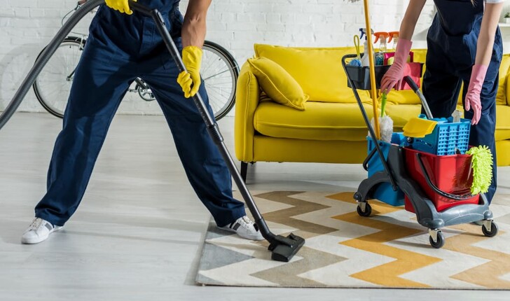cleaners tidying living room