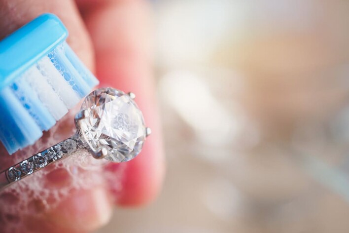 cleaning silver ring with toothbrush
