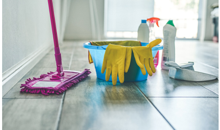 Pink mop, blue bucket and yellow gloves, cleaning utensils for cleaning the house.
