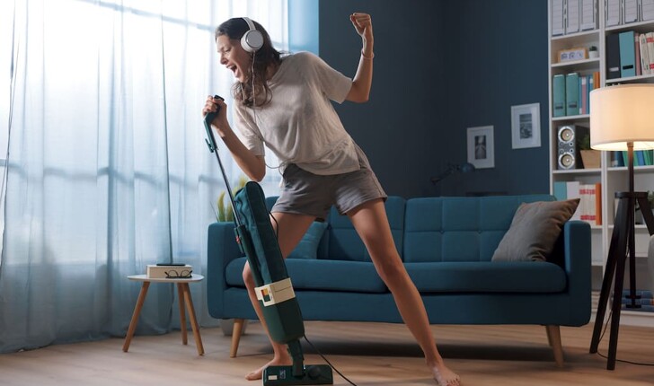 Woman singing while vacuuming
