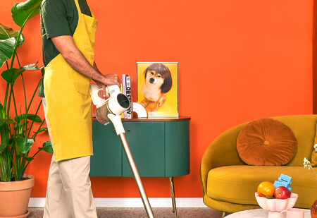 same day cleaning - housekeeper vacuuming the floor