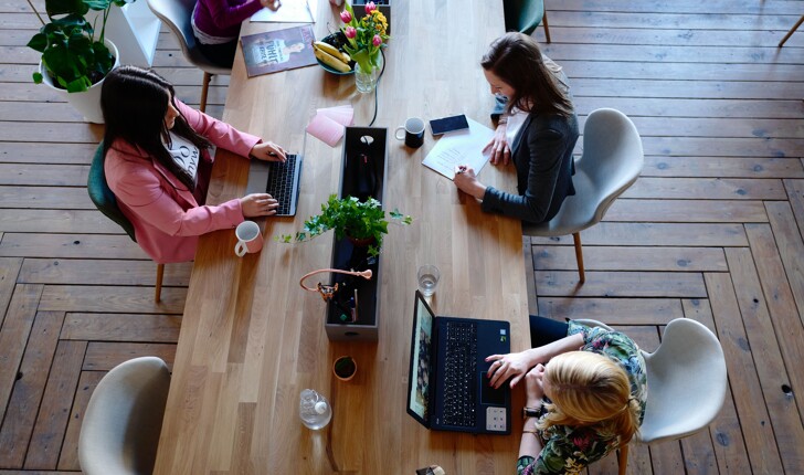 Three women working at the office at the working space-Office cleaning service near me 