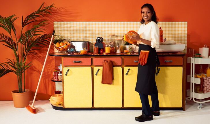Professional housekeeper cleaning the kitchen and doing the dishes 
