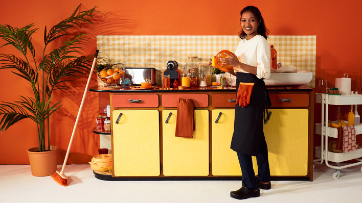 Wecasa professional cleaning lady doing the dishes and cleaning an orange kitchen